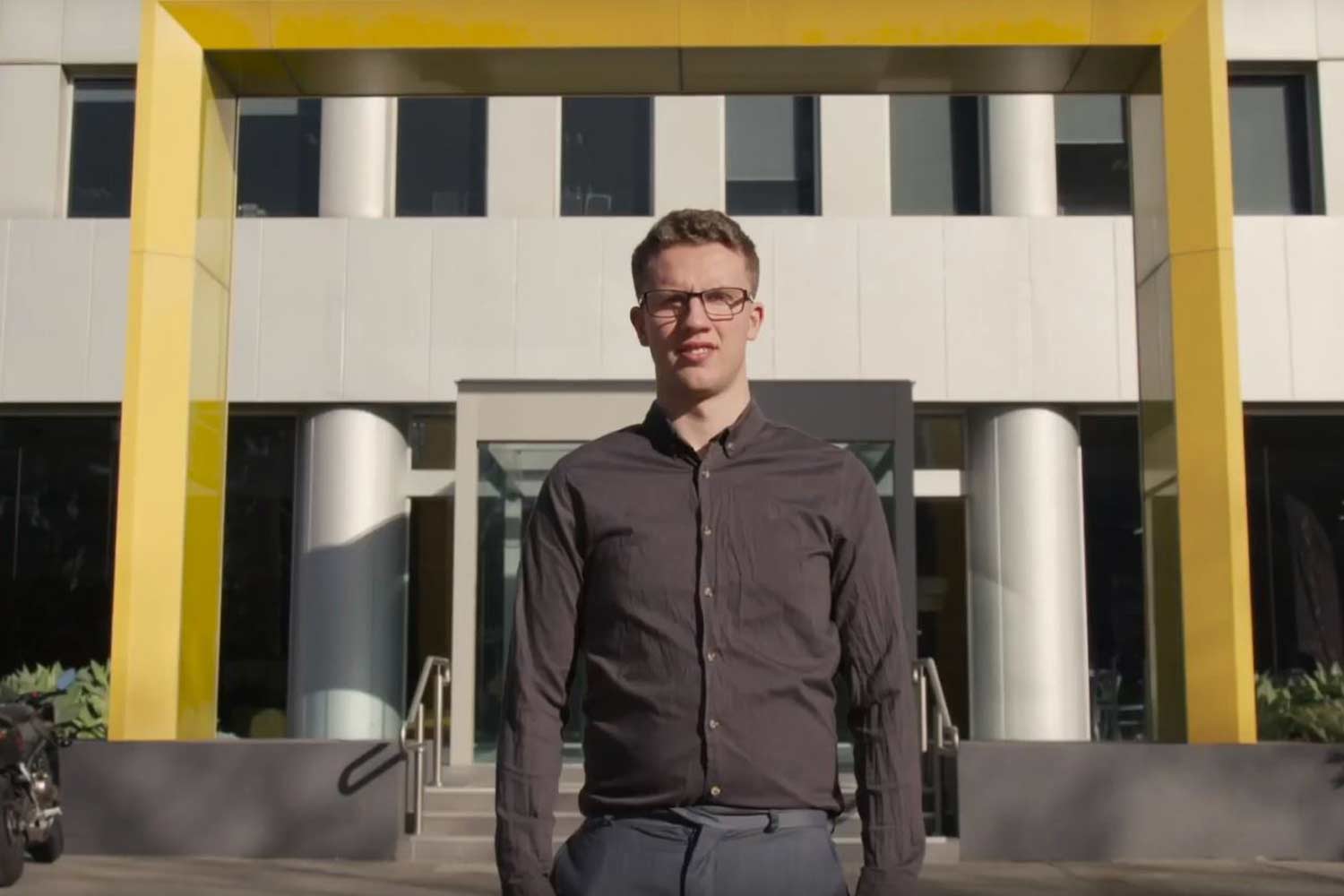 joshua standing infront of building